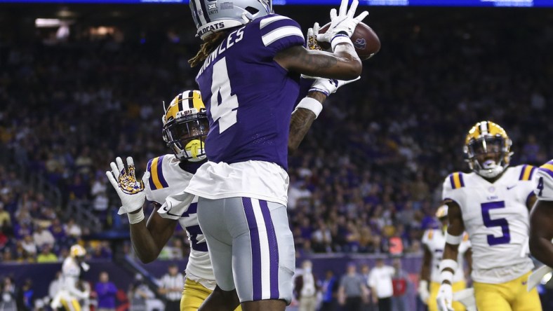 Jan 4, 2022; Houston, TX, USA; Kansas State Wildcats wide receiver Malik Knowles (4) makes a reception for a touchdown as LSU Tigers defensive back Damarius McGhee (26) defends during the second quarter during the 2022 Texas Bowl at NRG Stadium. Mandatory Credit: Troy Taormina-USA TODAY Sports