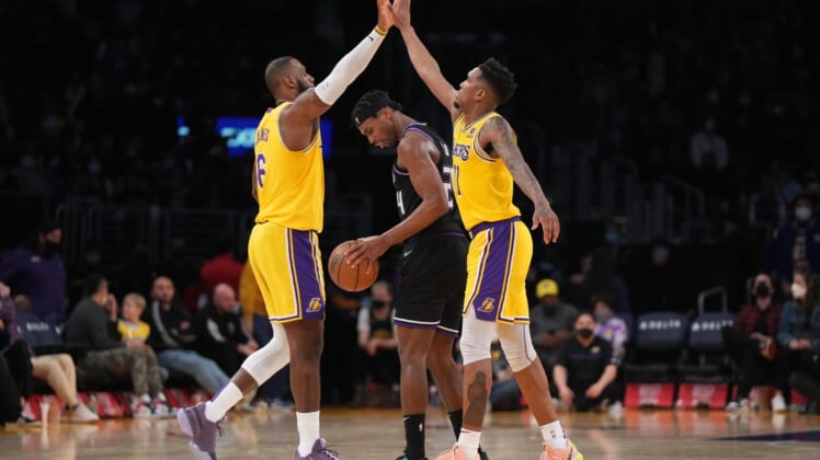 Jan 4, 2022; Los Angeles, California, USA; Los Angeles Lakers forward LeBron James (6) celebrates with guard Russell Westbrook (0) as Sacramento Kings guard Buddy Hield (24) reacts in the second half at Crypto.com Arena. Mandatory Credit: Kirby Lee-USA TODAY Sports