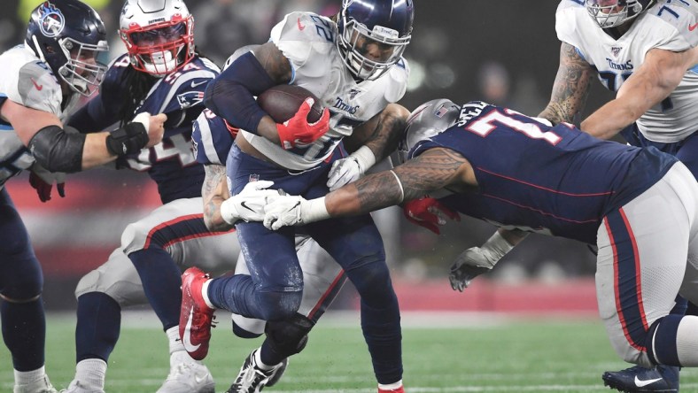 Tennessee Titans running back Derrick Henry (22) runs through the New England Patriots defense during the AFC Wild Card game at Gillette Stadium in Foxborough, Mass., Jan. 4, 2020.

Gw55073