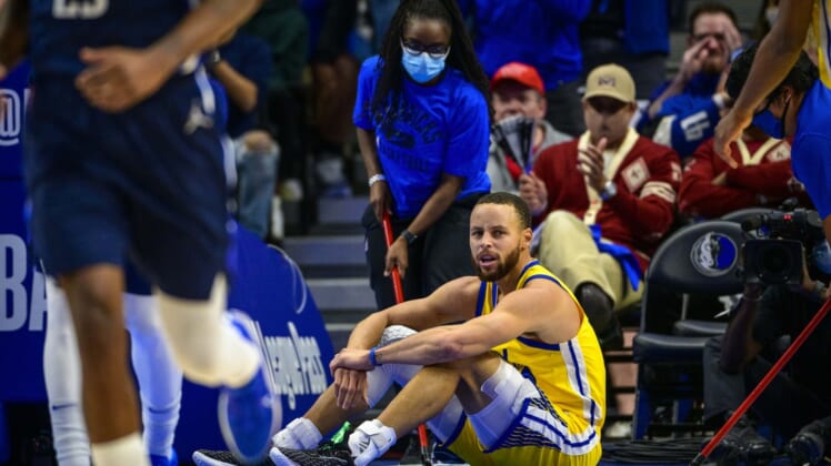 Jan 5, 2022; Dallas, Texas, USA; Golden State Warriors guard Stephen Curry (30) sits on the floor during the second quarter against the Dallas Mavericks at the American Airlines Center. Mandatory Credit: Jerome Miron-USA TODAY Sports