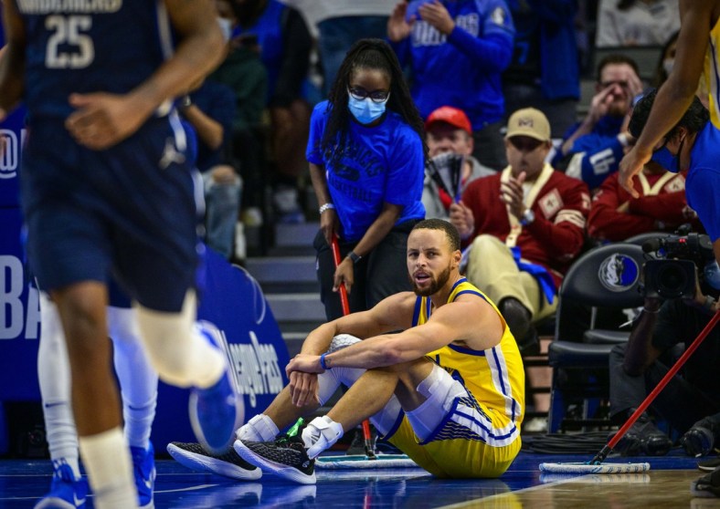 Jan 5, 2022; Dallas, Texas, USA; Golden State Warriors guard Stephen Curry (30) sits on the floor during the second quarter against the Dallas Mavericks at the American Airlines Center. Mandatory Credit: Jerome Miron-USA TODAY Sports