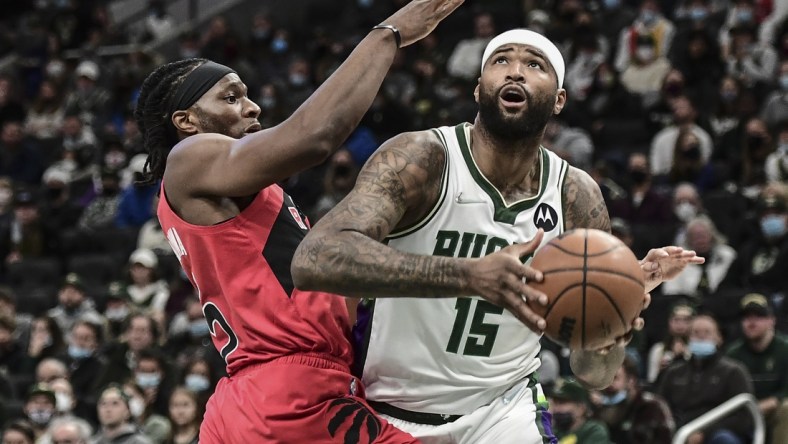 Jan 5, 2022; Milwaukee, Wisconsin, USA; Milwaukee Bucks center DeMarcus Cousins (15) looks for a shot against Toronto Raptors forward Precious Achiuwa (5) in the second quarter at Fiserv Forum. Mandatory Credit: Benny Sieu-USA TODAY Sports