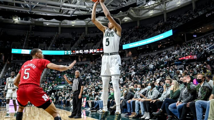 Michigan State's Max Christie, right, makes a 3-pointer as Nebraska's Bryce McGowens, left, closes in during the second half on Wednesday, Jan. 5, 2022, at the Breslin Center in East Lansing.220105 Msu Neb 170a