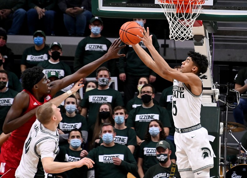 Jan 5, 2022; East Lansing, Michigan, USA; Michigan State Spartans guard Max Christie (5) takes a rebound away from forward Joey Hauser (10) and Nebraska Cornhuskers center Eduardo Andre (35) in the second half at Jack Breslin Student Events Center. Mandatory Credit: Dale Young-USA TODAY Sports