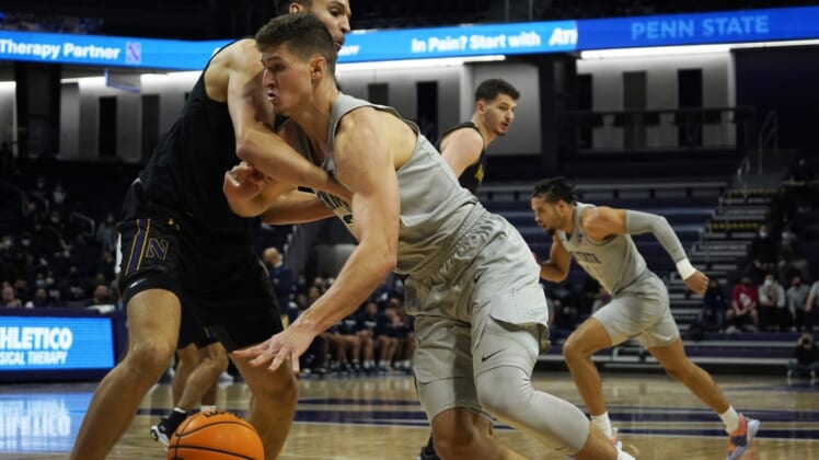 Jan 5, 2022; Evanston, Illinois, USA; Penn State Nittany Lions forward John Harrar (21) is defended by Northwestern Wildcats forward Pete Nance (22) during the first half at Welsh-Ryan Arena. Mandatory Credit: David Banks-USA TODAY Sports