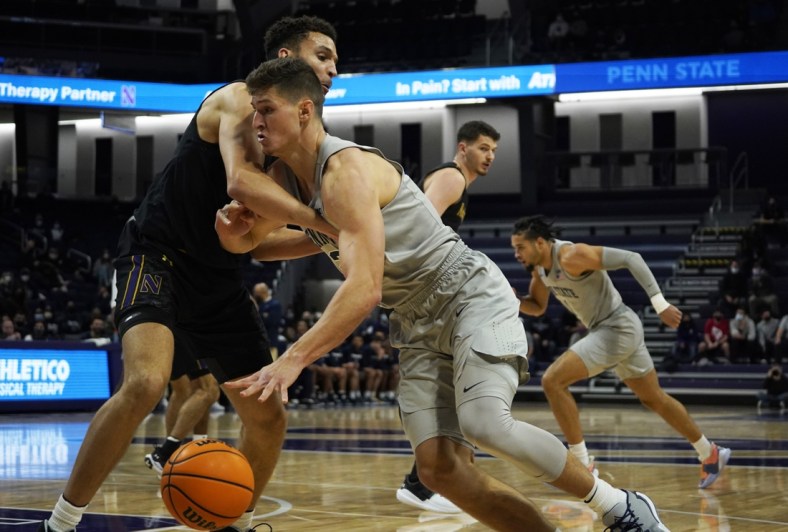 Jan 5, 2022; Evanston, Illinois, USA; Penn State Nittany Lions forward John Harrar (21) is defended by Northwestern Wildcats forward Pete Nance (22) during the first half at Welsh-Ryan Arena. Mandatory Credit: David Banks-USA TODAY Sports