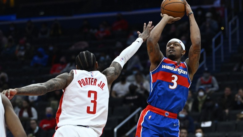 Jan 5, 2022; Washington, District of Columbia, USA; Washington Wizards guard Bradley Beal (3) shoots over Houston Rockets guard Kevin Porter Jr. (3) during the second half at Capital One Arena. Mandatory Credit: Brad Mills-USA TODAY Sports