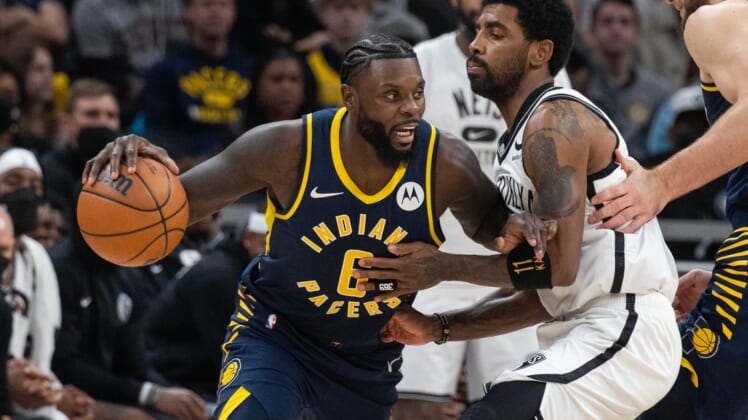 Jan 5, 2022; Indianapolis, Indiana, USA; Indiana Pacers guard Lance Stephenson (6) dribbles the ball while Brooklyn Nets guard Kyrie Irving (11) defends in the second half at Gainbridge Fieldhouse. Mandatory Credit: Trevor Ruszkowski-USA TODAY Sports