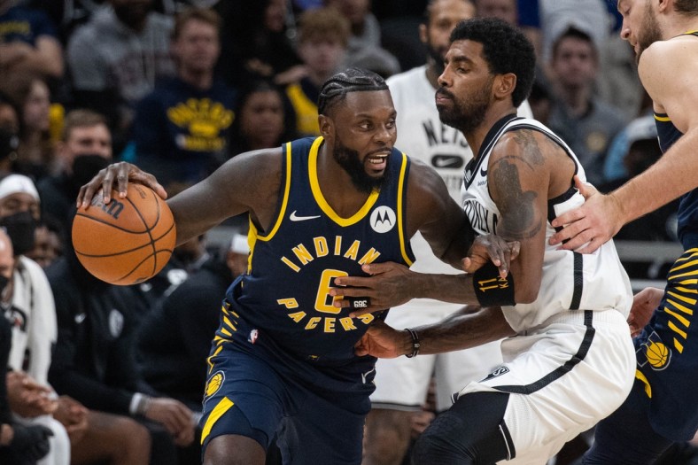 Jan 5, 2022; Indianapolis, Indiana, USA; Indiana Pacers guard Lance Stephenson (6) dribbles the ball while Brooklyn Nets guard Kyrie Irving (11) defends in the second half at Gainbridge Fieldhouse. Mandatory Credit: Trevor Ruszkowski-USA TODAY Sports