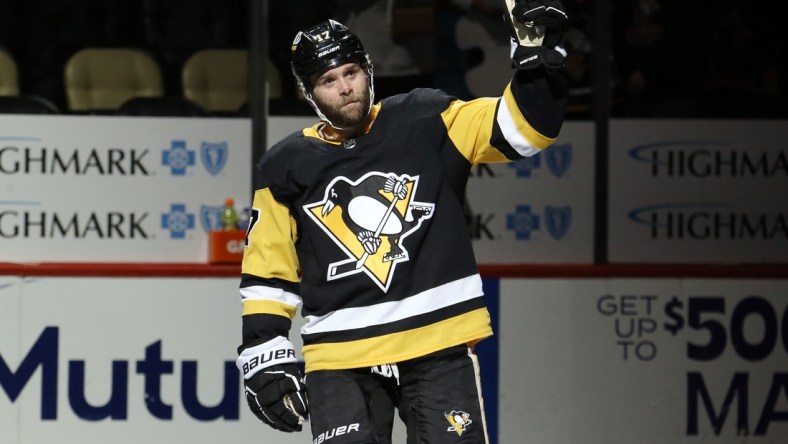 Jan 5, 2022; Pittsburgh, Pennsylvania, USA;  Pittsburgh Penguins right wing Bryan Rust (17) reacts after being named first star of the game against the St. Louis Blues at PPG Paints Arena. The Penguins won 5-3. Mandatory Credit: Charles LeClaire-USA TODAY Sports