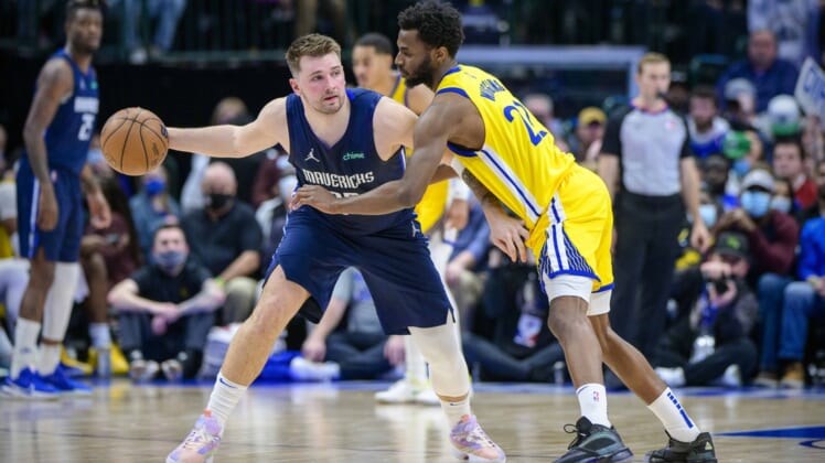 Jan 5, 2022; Dallas, Texas, USA; Golden State Warriors forward Andrew Wiggins (22) defends against Dallas Mavericks guard Luka Doncic (77) during the game between the Dallas Mavericks and the Golden State Warriors at the American Airlines Center. Mandatory Credit: Jerome Miron-USA TODAY Sports