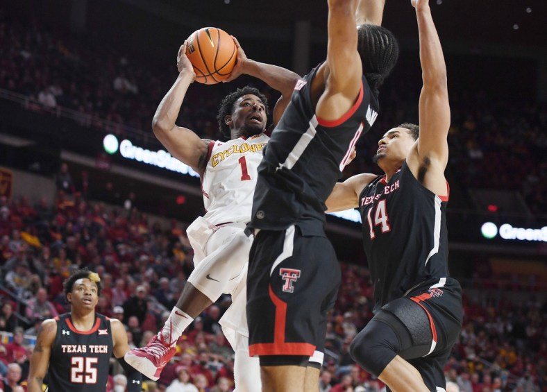 Iowa State Cyclones' guard Izaiah Brockington (1) takes a shot as Texas Tech Red Raiders' forward Kevin Obanor (0) and forward Marcus Santos-Silva (14) defend during the second half of an NCAA college basketball game at Hilton Coliseum Wednesday, Jan 6. 2022, in Ames, Iowa.