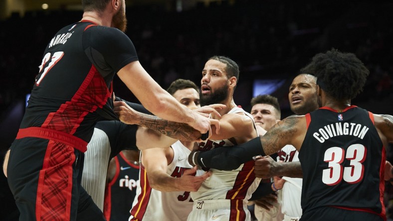 Jan 5, 2022; Portland, Oregon, USA; Miami Heat forward Caleb Martin (16) separates Portland Trail Blazers center Jusuf Nurkic (27) from guard Tyler Herro (14) during the second half at Moda Center. The Heat won the game 115-109. Mandatory Credit: Troy Wayrynen-USA TODAY Sports