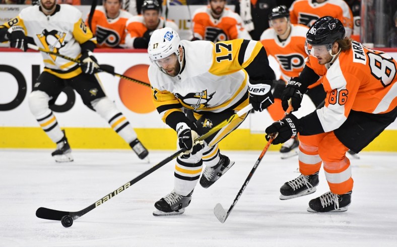 Jan 6, 2022; Philadelphia, Pennsylvania, USA; Pittsburgh Penguins right wing Bryan Rust (17) and Philadelphia Flyers left wing Joel Farabee (86) battle for the puck during the first period at Wells Fargo Center. Mandatory Credit: Eric Hartline-USA TODAY Sports