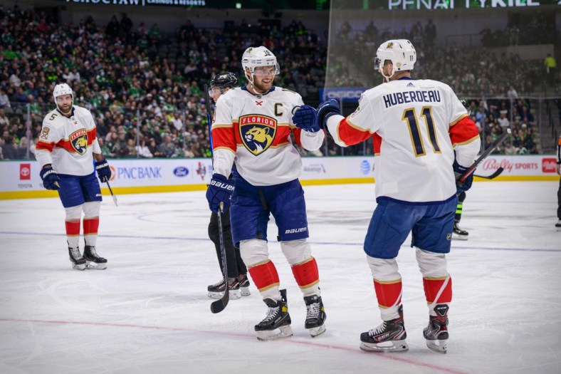 Jan 6, 2022; Dallas, Texas, USA; Florida Panthers defenseman Aaron Ekblad (5) and center Aleksander Barkov (16) and left wing Jonathan Huberdeau (11) celebrates a goal scored by Huberdeau against the Dallas Stars during the first period at the American Airlines Center. Mandatory Credit: Jerome Miron-USA TODAY Sports