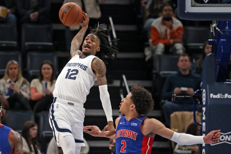 Jan 6, 2022; Memphis, Tennessee, USA; Memphis Grizzles guard Ja Morant (12) attempts to save a ball form going out of bounds during the first half against the Detroit Pistons at FedExForum. Mandatory Credit: Petre Thomas-USA TODAY Sports
