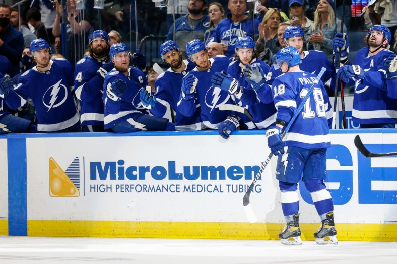 Jan 6, 2022; Tampa, Florida, USA; Tampa Bay Lightning left wing Ondrej Palat (18) is congratulated after scoring a goal in the third period against the Calgary Flames at Amalie Arena. Mandatory Credit: Nathan Ray Seebeck-USA TODAY Sports
