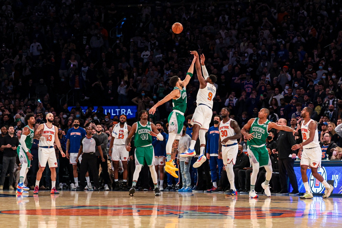 Jan 6, 2022; New York, New York, USA; New York Knicks guard RJ Barrett (9) makes a game-winning three point basket during the fourth quarter as Boston Celtics forward Jayson Tatum (0) defends at Madison Square Garden. Mandatory Credit: Vincent Carchietta-USA TODAY Sports