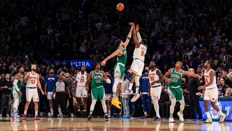 Jan 6, 2022; New York, New York, USA; New York Knicks guard RJ Barrett (9) makes a game-winning three point basket during the fourth quarter as Boston Celtics forward Jayson Tatum (0) defends at Madison Square Garden. Mandatory Credit: Vincent Carchietta-USA TODAY Sports