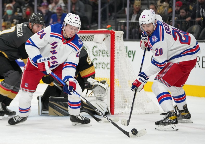 Jan 6, 2022; Las Vegas, Nevada, USA; New York Rangers right wing Kaapo Kakko (24) takes the puck from left wing Chris Kreider (20) during the first period against the Vegas Golden Knights at T-Mobile Arena. Mandatory Credit: Stephen R. Sylvanie-USA TODAY Sports