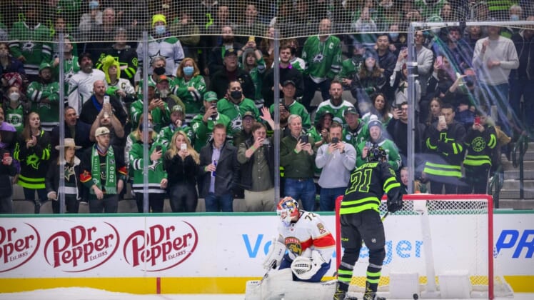 Jan 6, 2022; Dallas, Texas, USA; Dallas Stars left wing Jason Robertson (21) scores against Florida Panthers goaltender Sergei Bobrovsky (72) during the overtime shootout period as the Stars fans look on at the American Airlines Center. Mandatory Credit: Jerome Miron-USA TODAY Sports