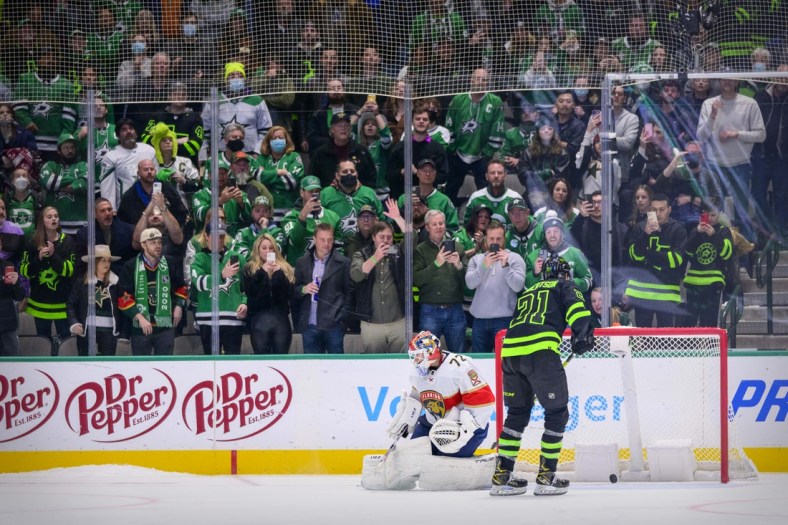 Jan 6, 2022; Dallas, Texas, USA; Dallas Stars left wing Jason Robertson (21) scores against Florida Panthers goaltender Sergei Bobrovsky (72) during the overtime shootout period as the Stars fans look on at the American Airlines Center. Mandatory Credit: Jerome Miron-USA TODAY Sports