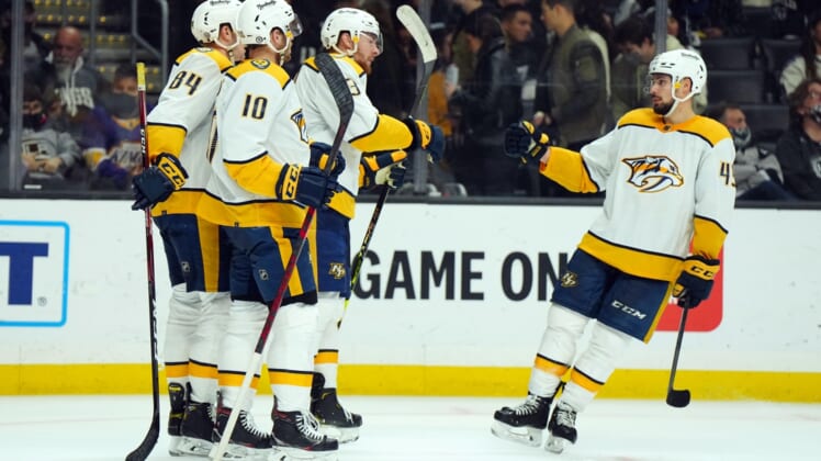 Jan 6, 2022; Los Angeles, California, USA; Nashville Predators left wing Tanner Jeannot (84) and center Colton Sissons (10), center Yakov Trenin (13) and defenseman Alexandre Carrier (45) celebrate after a goal against the LA Kings in the third period at Crypto.com Arena. Mandatory Credit: Kirby Lee-USA TODAY Sports