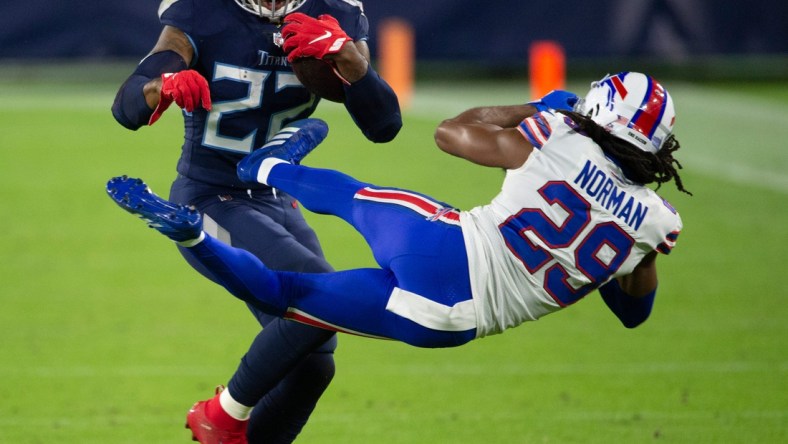 Tennessee Titans running back Derrick Henry (22) throws Buffalo Bills cornerback Josh Norman (29) aside as he rushes up the field during the second quarter at Nissan Stadium Tuesday, Oct. 13, 2020 in Nashville, Tenn.

Nas Titans Bills 001