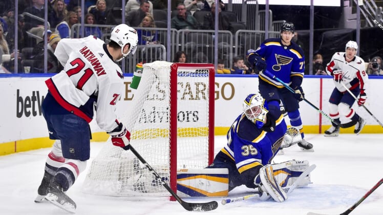 Jan 7, 2022; St. Louis, Missouri, USA;  St. Louis Blues goaltender Ville Husso (35) defends the net against Washington Capitals right wing Garnet Hathaway (21) during the first period at Enterprise Center. Mandatory Credit: Jeff Curry-USA TODAY Sports