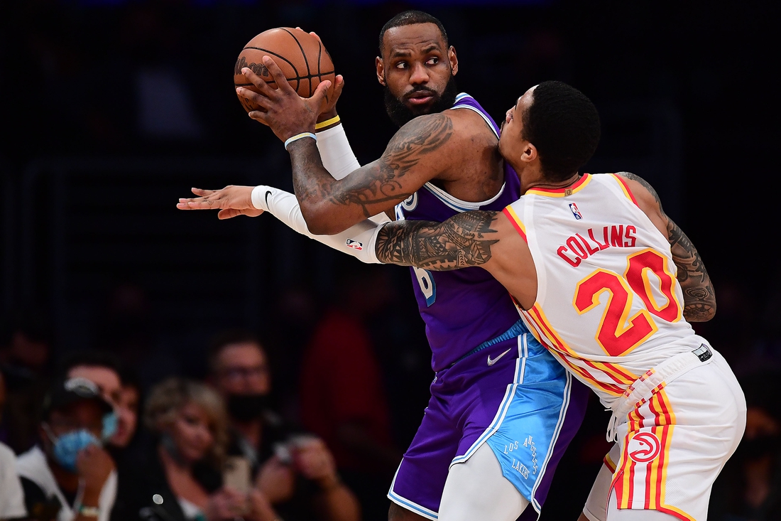 Jan 7, 2022; Los Angeles, California, USA; Los Angeles Lakers forward LeBron James (6) moves the ball against Atlanta Hawks forward John Collins (20) during the first half at Crypto.com Arena. Mandatory Credit: Gary A. Vasquez-USA TODAY Sports