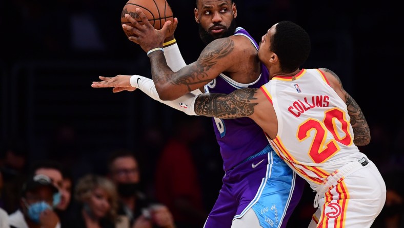 Jan 7, 2022; Los Angeles, California, USA; Los Angeles Lakers forward LeBron James (6) moves the ball against Atlanta Hawks forward John Collins (20) during the first half at Crypto.com Arena. Mandatory Credit: Gary A. Vasquez-USA TODAY Sports