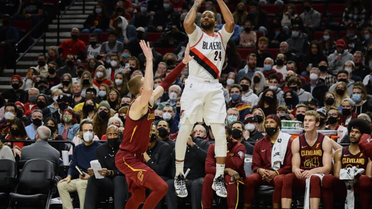 Jan 7, 2022; Portland, Oregon, USA;  Portland Trail Blazers forward Norman Powell (24) shoots a three point basket during the second half against Cleveland Cavaliers guard Dylan Windler (9) at Moda Center. The Cavaliers won 114-101. Mandatory Credit: Troy Wayrynen-USA TODAY Sports