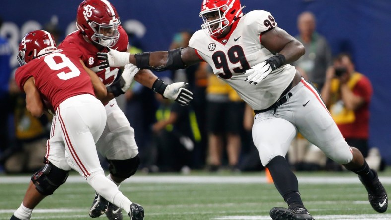 Alabama quarterback Bryce Young (9) avoids Georgia's Jordan Davis (99) during the SEC championship game Dec. 4 in Atlanta.

Syndication Online Athens