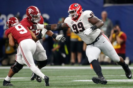 Alabama quarterback Bryce Young (9) avoids Georgia's Jordan Davis (99) during the SEC championship game Dec. 4 in Atlanta.

Syndication Online Athens