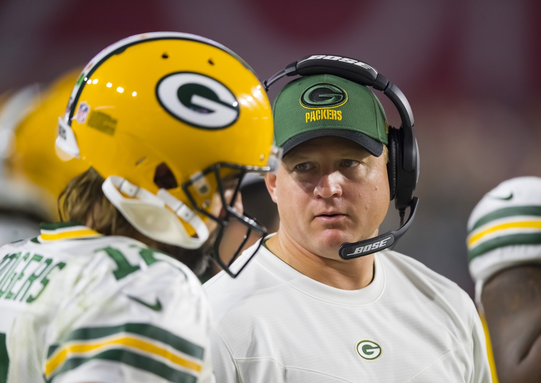 Oct 28, 2021; Glendale, Arizona, USA; Green Bay Packers quarterbacks coach Luke Getsy talks to Aaron Rodgers (12) against the Arizona Cardinals at State Farm Stadium. Mandatory Credit: Mark J. Rebilas-USA TODAY Sports