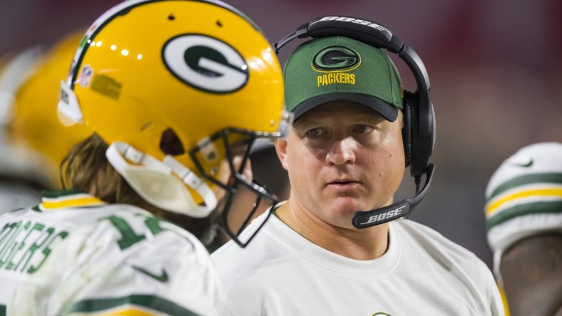 Oct 28, 2021; Glendale, Arizona, USA; Green Bay Packers quarterbacks coach Luke Getsy talks to Aaron Rodgers (12) against the Arizona Cardinals at State Farm Stadium. Mandatory Credit: Mark J. Rebilas-USA TODAY Sports