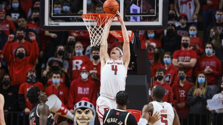 Jan 8, 2022; Piscataway, New Jersey, USA; Rutgers Scarlet Knights guard Paul Mulcahy (4) makes a basket in front of Nebraska Cornhuskers center Eduardo Andre (35) and guard Alonzo Verge Jr. (1) and forward Aundre Hyatt (5) during the first half at Jersey Mike's Arena. Mandatory Credit: Vincent Carchietta-USA TODAY Sports
