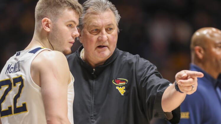 Jan 8, 2022; Morgantown, West Virginia, USA; West Virginia Mountaineers head coach Bob Huggins talks with West Virginia Mountaineers guard Sean McNeil (22) during the second half against the Kansas State Wildcats at WVU Coliseum. Mandatory Credit: Ben Queen-USA TODAY Sports