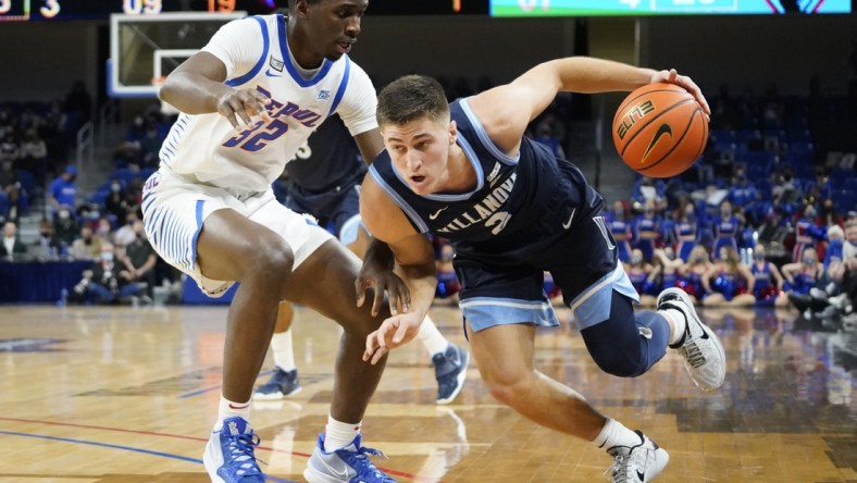 Jan 8, 2022; Chicago, Illinois, USA; DePaul Blue Demons forward David Jones (32) defends Villanova Wildcats guard Collin Gillespie (2) during the first half at Wintrust Arena. Mandatory Credit: David Banks-USA TODAY Sports