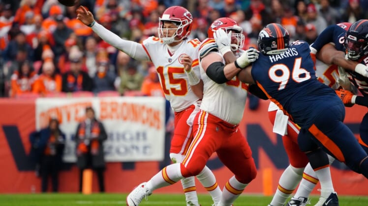 Jan 8, 2022; Denver, Colorado, USA; Kansas City Chiefs quarterback Patrick Mahomes (15) attempts a pass as guard Joe Thuney (62) defends against Denver Broncos defensive end Shelby Harris (96) in the first quarter at Empower Field at Mile High. Mandatory Credit: Ron Chenoy-USA TODAY Sports