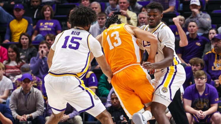 Jan 8, 2022; Baton Rouge, Louisiana, USA;   Tennessee Volunteers forward Olivier Nkamhoua (13) is fouled by LSU Tigers forward Darius Days (4) during the fist half at Pete Maravich Assembly Center. Mandatory Credit: Stephen Lew-USA TODAY Sports