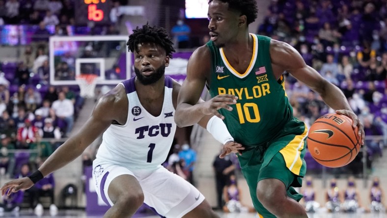 Jan 8, 2022; Fort Worth, Texas, USA;  Baylor Bears guard Adam Flagler (10) drives to the basket past TCU Horned Frogs guard Mike Miles (1) during the second half at Ed and Rae Schollmaier Arena. Mandatory Credit: Chris Jones-USA TODAY Sports