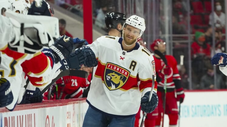 Jan 8, 2022; Raleigh, North Carolina, USA;  Florida Panthers left wing Jonathan Huberdeau (11) celebrates his goal against the Carolina Hurricanes during the first period at PNC Arena. Mandatory Credit: James Guillory-USA TODAY Sports