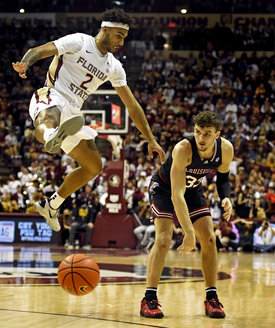 Jan 8, 2022; Tallahassee, Florida, USA; Louisville Cardinals forward Matt Cross (33) passes the ball against Florida State Seminoles guard Anthony Polite (2) during the first half at Donald L. Tucker Center. Mandatory Credit: Melina Myers-USA TODAY Sports