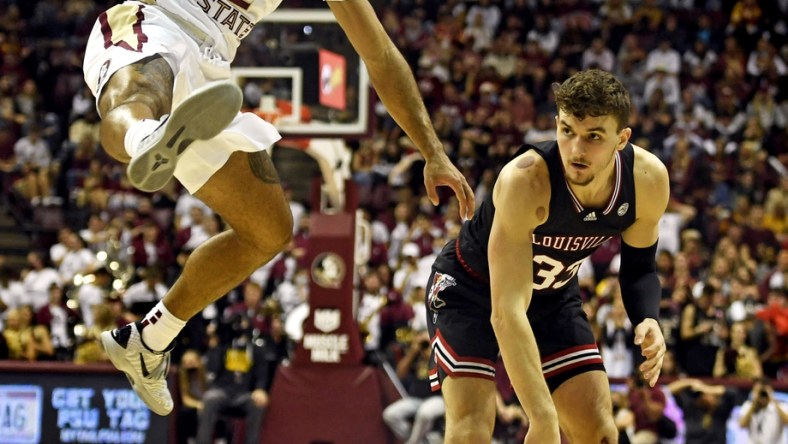 Jan 8, 2022; Tallahassee, Florida, USA; Louisville Cardinals forward Matt Cross (33) passes the ball against Florida State Seminoles guard Anthony Polite (2) during the first half at Donald L. Tucker Center. Mandatory Credit: Melina Myers-USA TODAY Sports