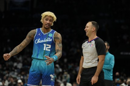 Jan 8, 2022; Charlotte, North Carolina, USA; Charlotte Hornets guard Kelly Oubre Jr. (12) talks with official Kane Fitzgerald (5) during the second half against the Milwaukee Bucks at the Spectrum Center. Mandatory Credit: Jim Dedmon-USA TODAY Sports