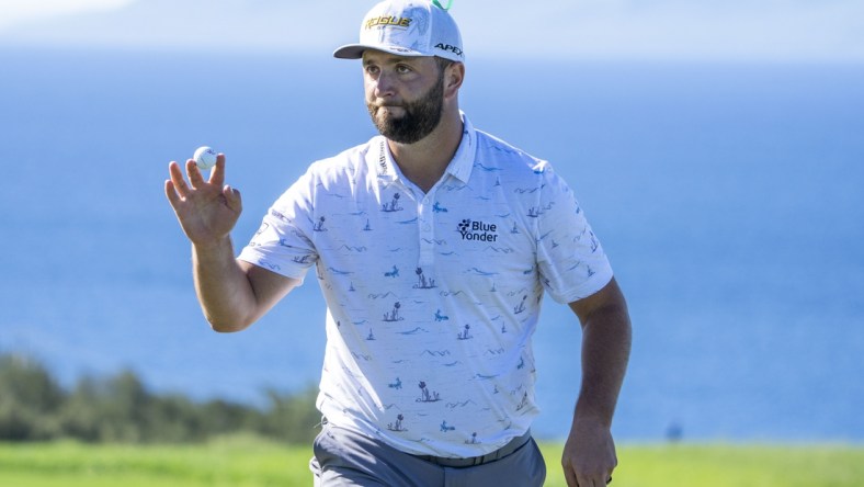 January 8, 2022; Maui, Hawaii, USA; Jon Rahm acknowledges the crowd after making his putt on the 10th hole during the third round of the Sentry Tournament of Champions golf tournament at Kapalua Resort - The Plantation Course. Mandatory Credit: Kyle Terada-USA TODAY Sports