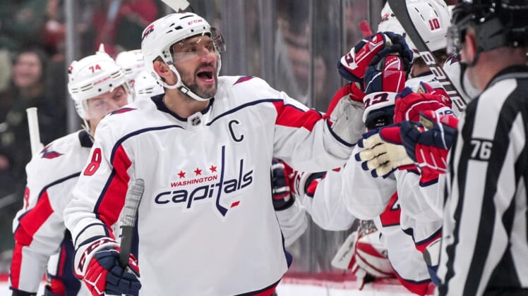 Jan 8, 2022; Saint Paul, Minnesota, USA;  Washington Capitals left wing Alex Ovechkin (8) celebrates after goal by center Evgeny Kuznetsov (92) against the Minnesota Wild in the second period at Xcel Energy Center. Mandatory Credit: Brad Rempel-USA TODAY Sports
