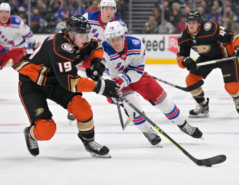 Jan 8, 2022; Anaheim, California, USA;  Anaheim Ducks right wing Troy Terry (19) and New York Rangers defenseman Adam Fox (23) battle for the puck in the first period of the game at Honda Center. Mandatory Credit: Jayne Kamin-Oncea-USA TODAY Sports