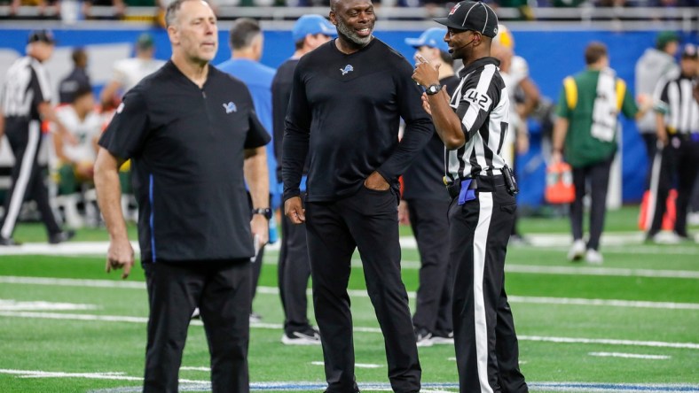 Lions offensive coordinator Anthony Lynn, center, speaks to a game official during warmups before the game against the Packers on Sunday, Jan. 9, 2022, at Ford Field.